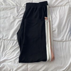 Black pants with peach pink and white stripes